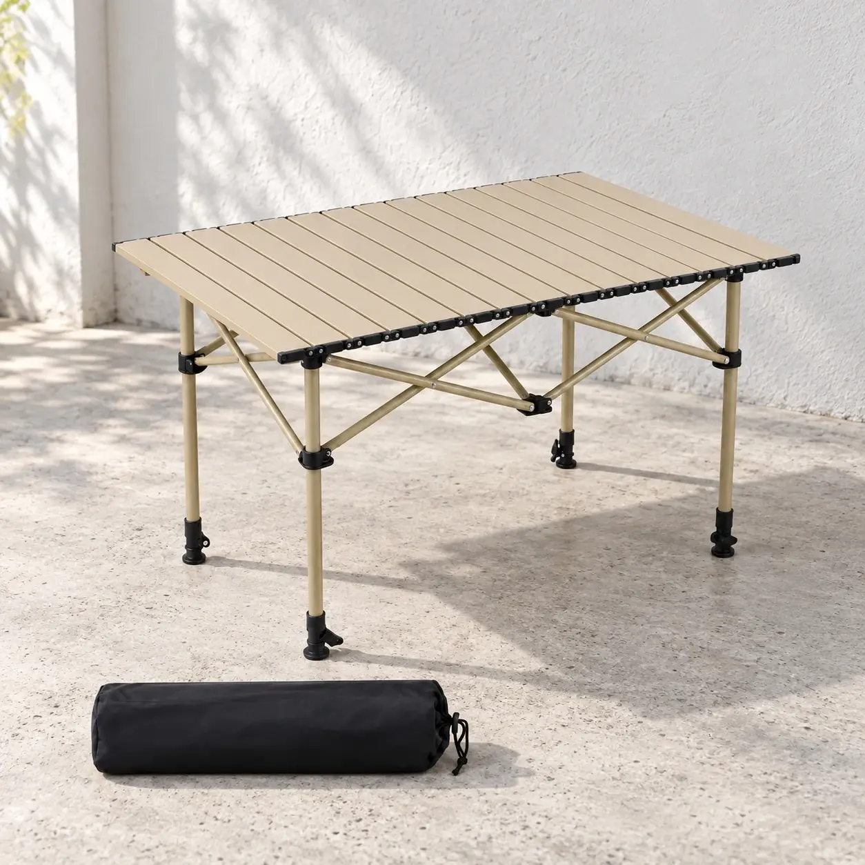 Beige folding terrace table with its black carry bag