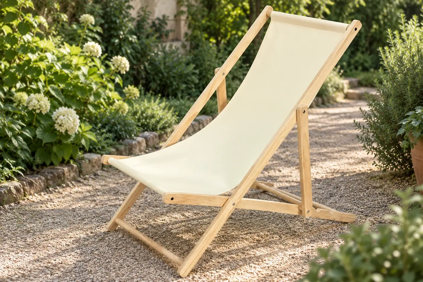 Canvas deck chair beside a sunlit garden path