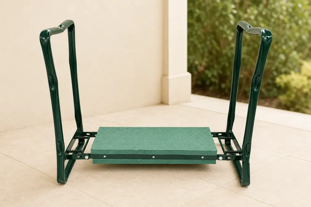 Green folding kneeler standing open on a terrace