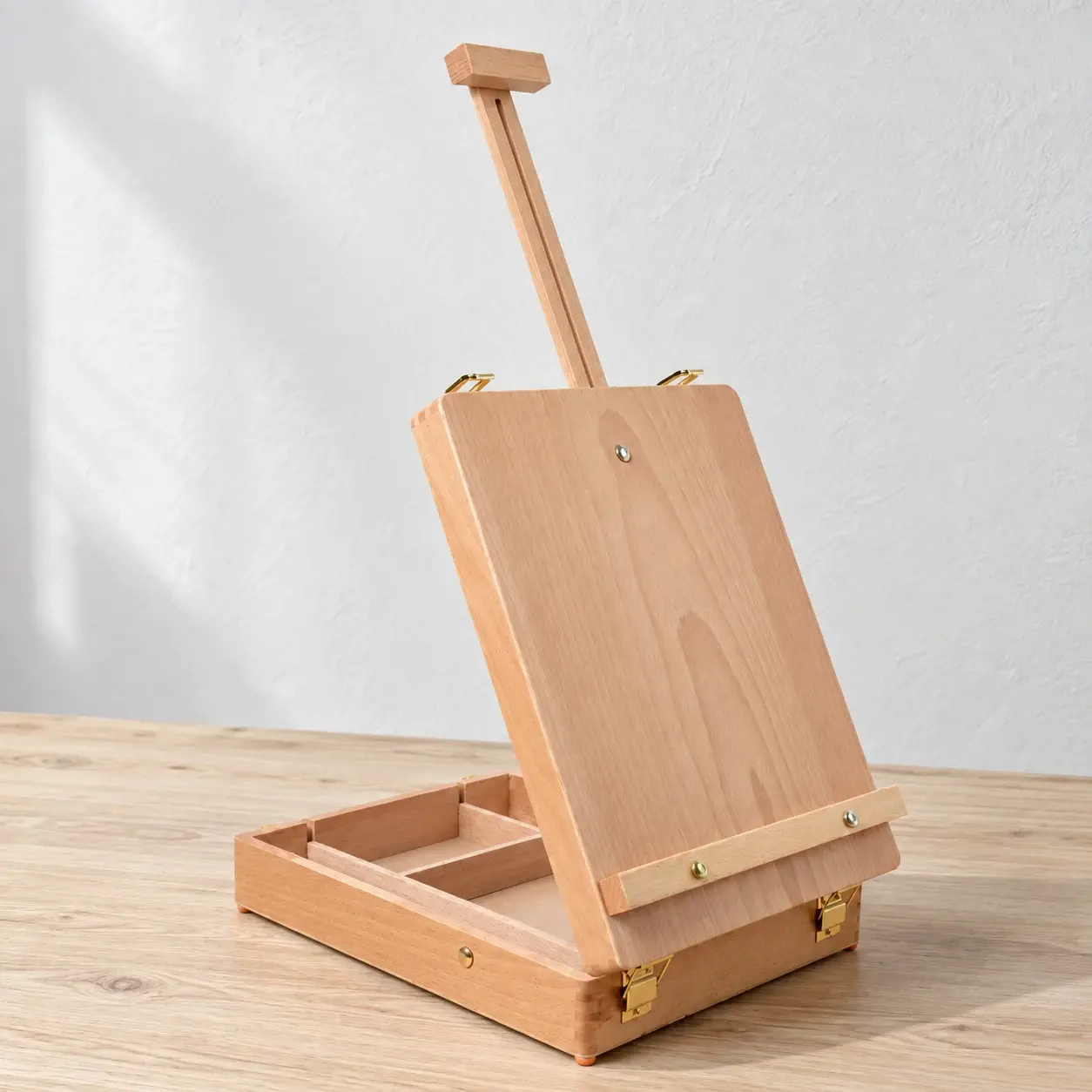 Open beech easel box on a natural wood worktable