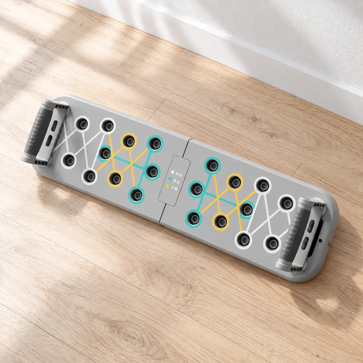 Gray folding push-up platform with two handles and original color guide on natural daylight
